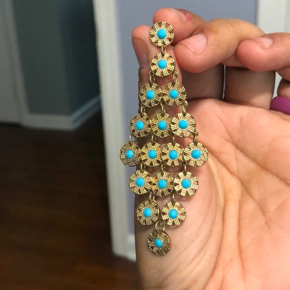 Gold-tone “turquoise” earrings.
